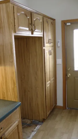 The kitchen provides space for a large refrigerator and freezer.