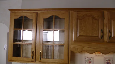 Another view of the glass-paned, finished oak cabinets.