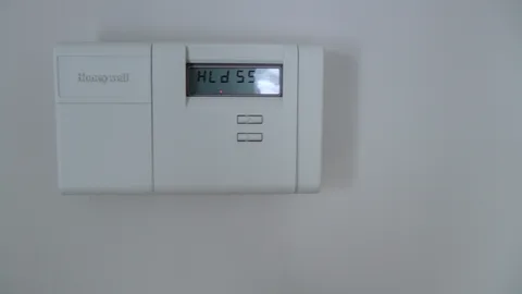 This thermostat, located in the dining room, controls the central heating.