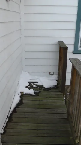 The previous occupant used this walkway, two lefts from the kitchen door, to position her working grill.